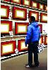 Flat Screens- stores and interiors- hyperrealism  painting of man in Media Markt electronic shop by artist Gerard Boersma