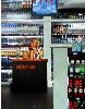Liquor Store- hyperrealism acrylic painting by artist painter Gerard Boersma showing a woman working in a liquor store, Las Vegas